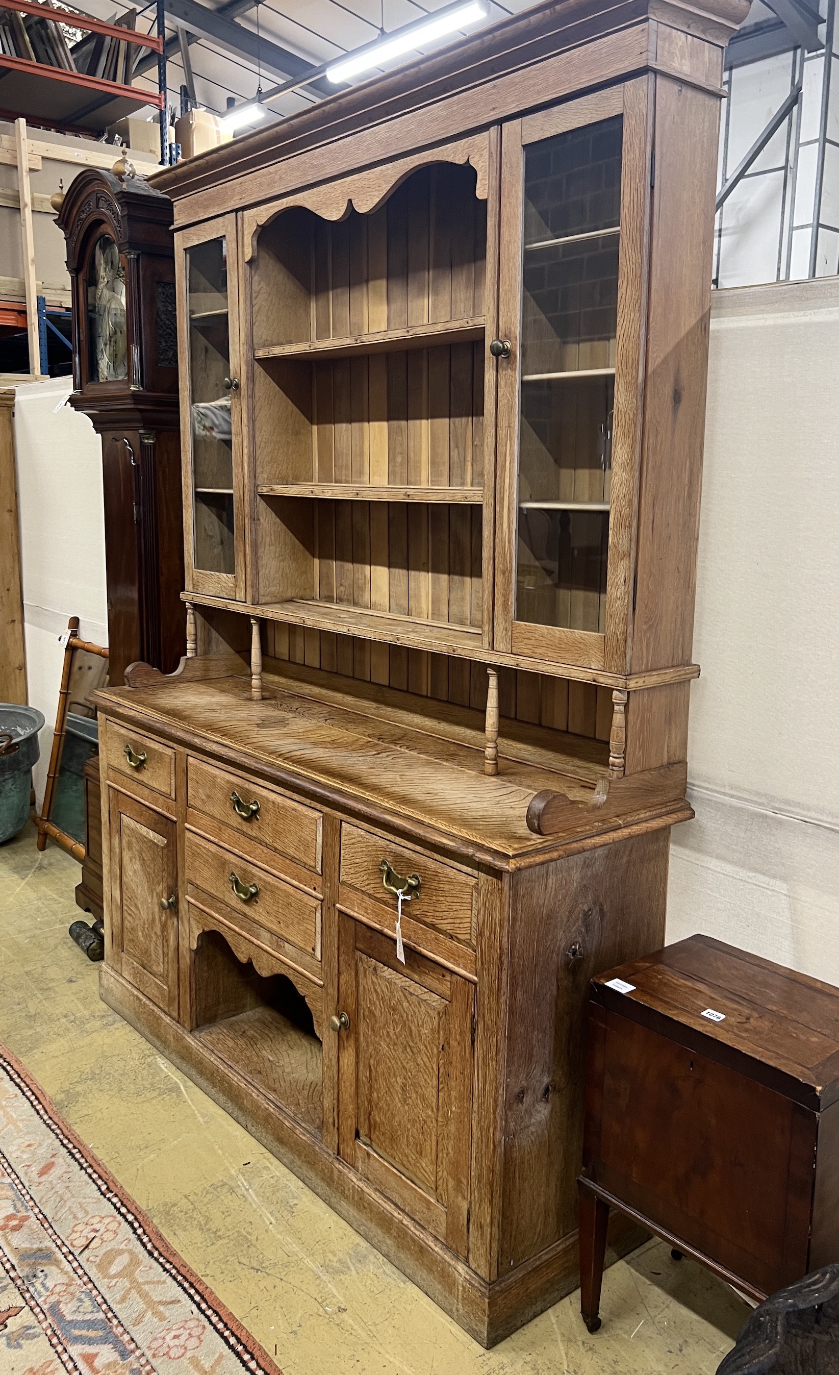 An early 20th century bleached oak dresser, width 165cm, depth 48cm, height 223cm